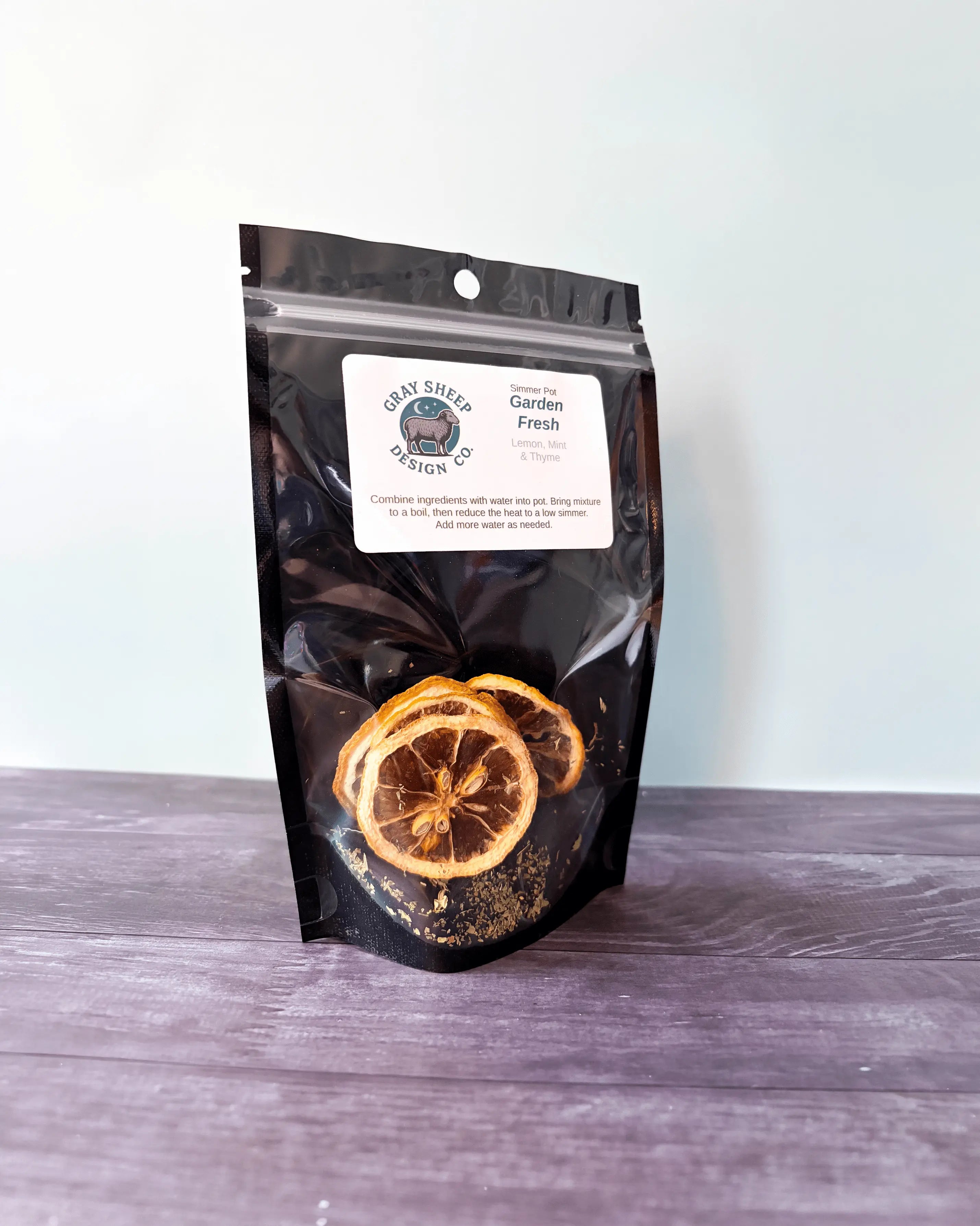 Garden Fresh simmer pot in a resealable black pouch, dried lemon slices and herbs visible through the window.