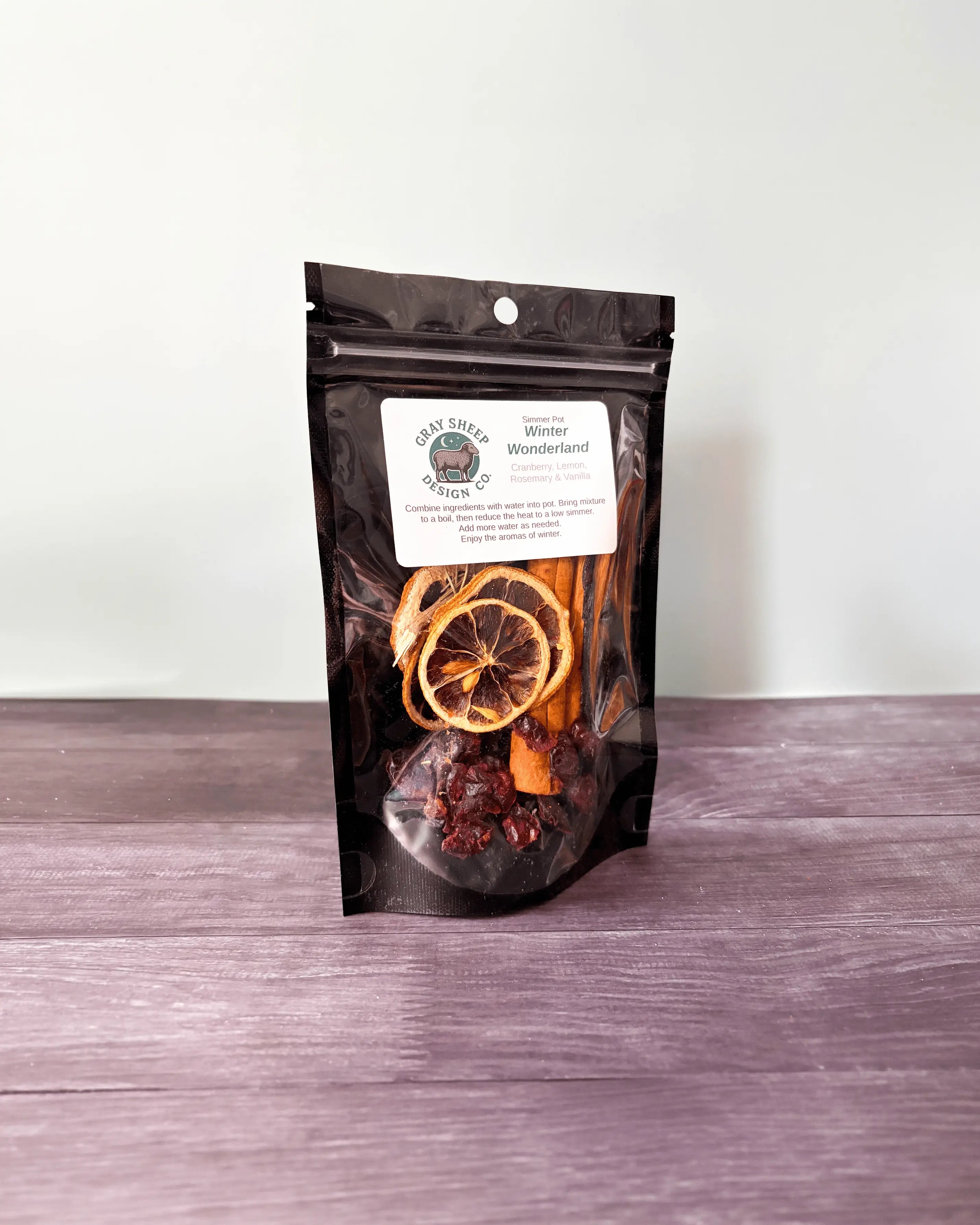 Winter Wonderland simmer pot in a resealable black pouch, dried cranberries and citrus slices visible through the window.